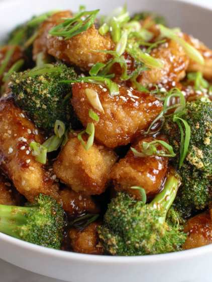 A bowl of chicken and broccoli.