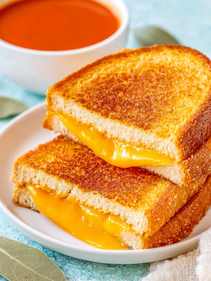 A grilled cheese sandwich with melted cheese.