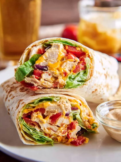 A plate with two southwest chicken wraps.