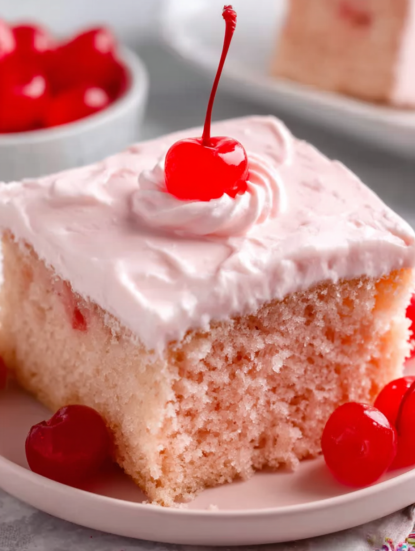 A slice of cake with a cherry on top.