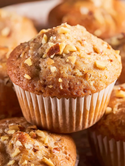 A muffin with nuts on top.