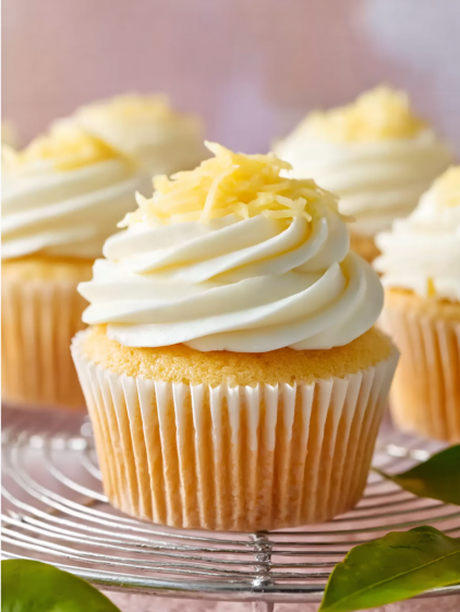 A cupcake with yellow frosting and white frosting.