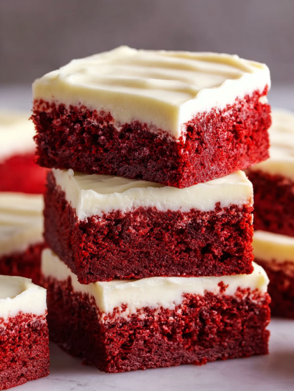 Red velvet brownies stacked on top of each other.