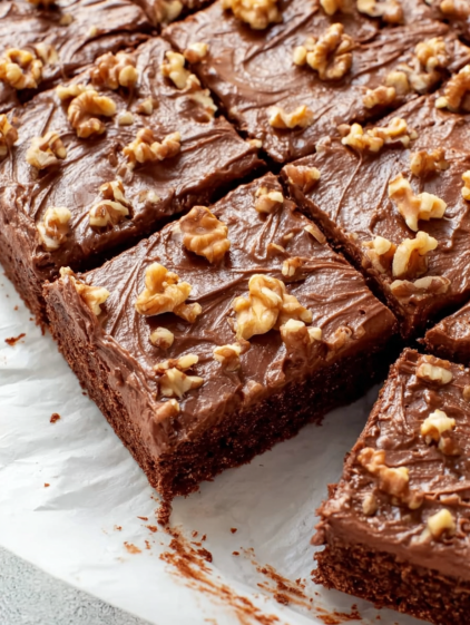 A slice of Texas Sheet Cake with walnuts.