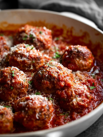 A bowl of meatballs in a red sauce.