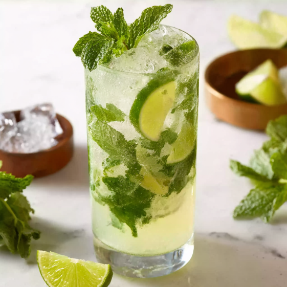 A glass of mojito with mint leaves.