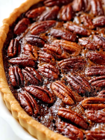 A slice of pecan pie with a golden crust.
