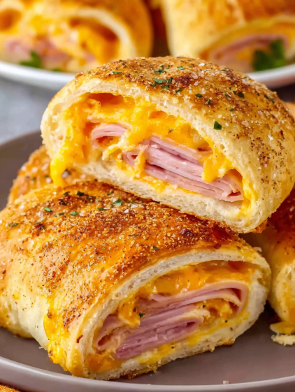 A close up of a delicious ham and cheese stromboli.