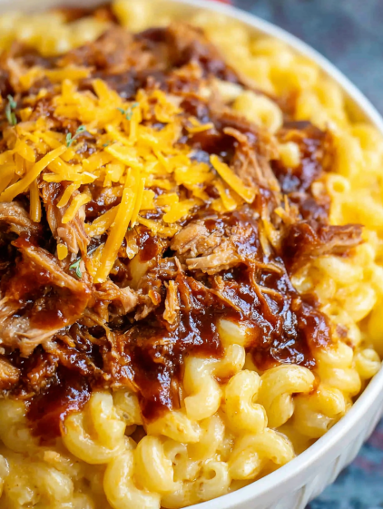 A close up of a delicious pulled pork macaroni and cheese dish.