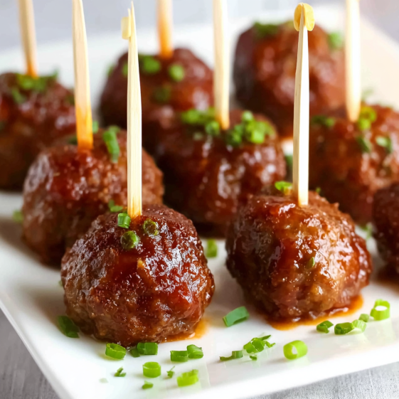 Meatballs on a plate with toothpicks.