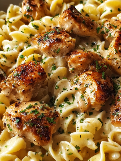 Chicken pieces in a creamy sauce with pasta.
