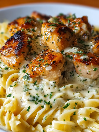 A plate of chicken with a creamy sauce.