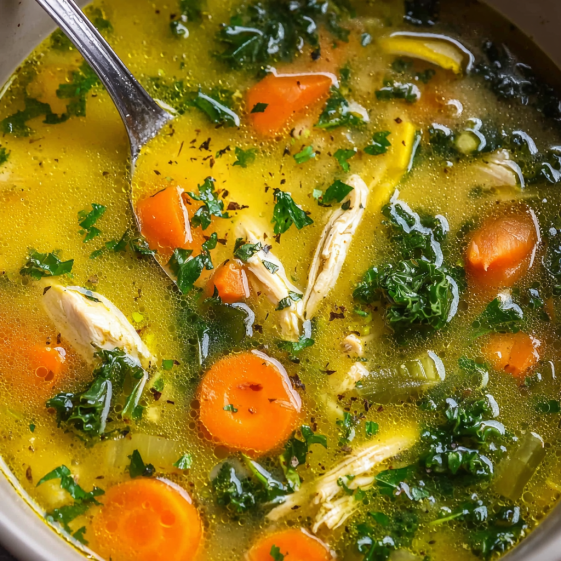 A bowl of soup with a spoon in it.