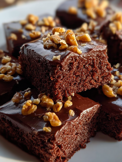Chocolate cake with nuts on top.