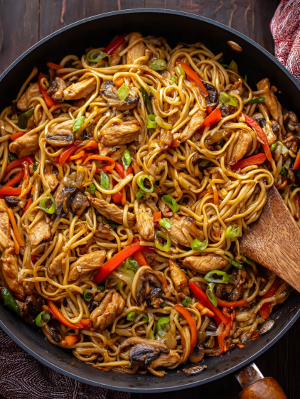 A bowl of Asian noodles with chicken and vegetables.