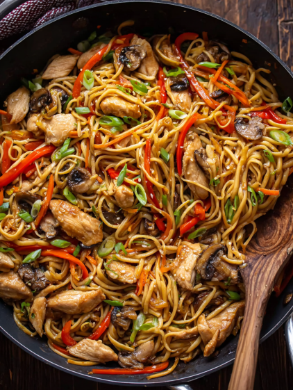 A bowl of Asian noodles with chicken and vegetables.
