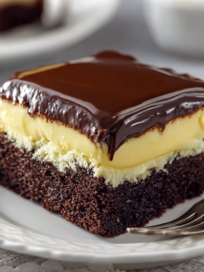 A slice of chocolate cake with white frosting.