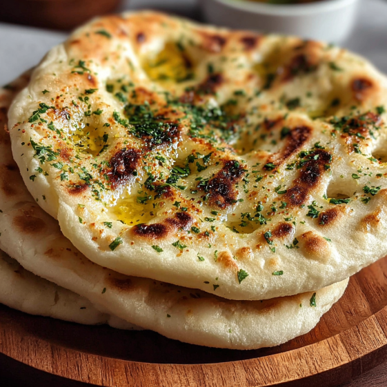 A stack of bread on a wooden board.