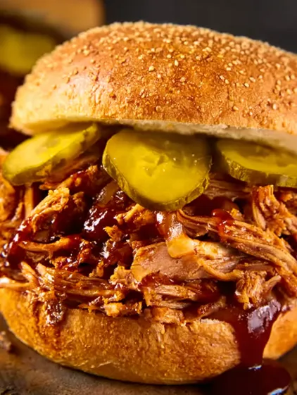 A close up of a pulled pork sandwich.