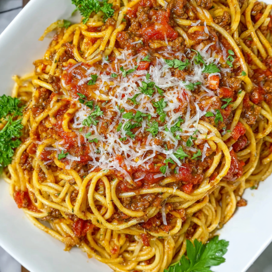 A bowl of spaghetti and meat.