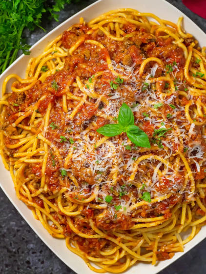 A plate of spaghetti with meat sauce and cheese.