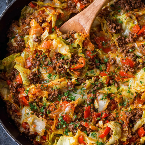 A skillet filled with ground beef and cabbage.