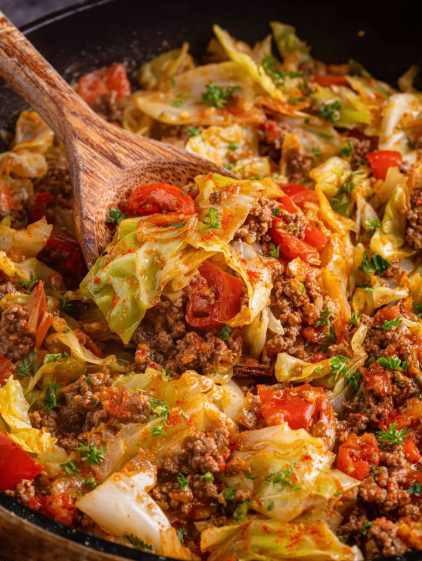A close up of a delicious cheesy ground beef and cabbage skillet.