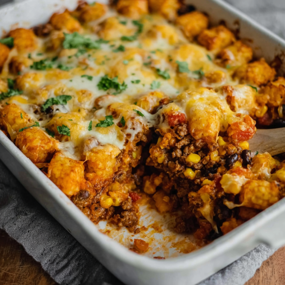 A white dish with a Mexican Tater Tot Casserole.