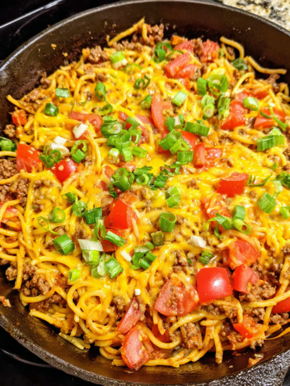 A delicious meal of spaghetti with meat and vegetables.