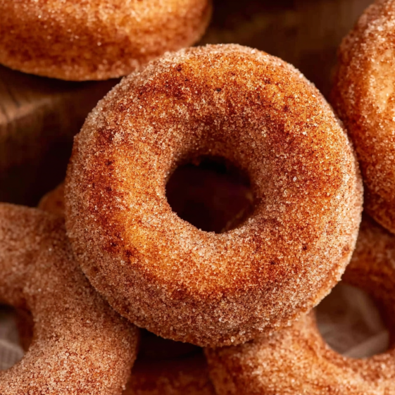 A pile of sugar coated donuts.