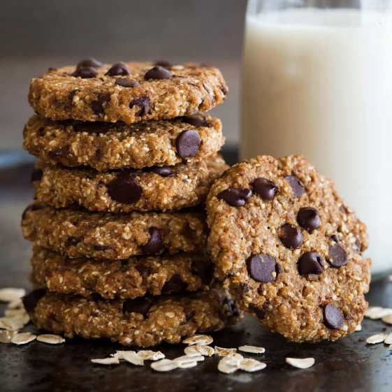 A stack of chocolate chip cookies with milk.