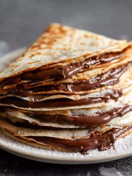 A stack of chocolate covered crepes.