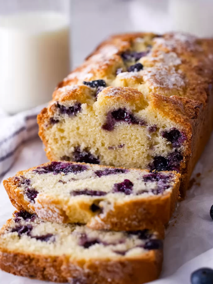 A loaf of bread with blueberries on top.