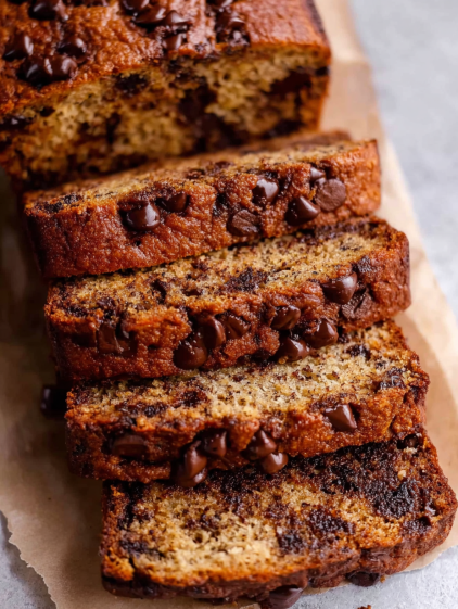 A slice of chocolate cake with chocolate chips.