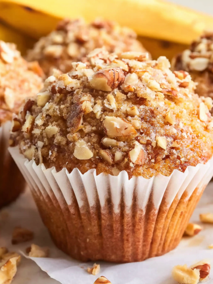 A cupcake with nuts on top.