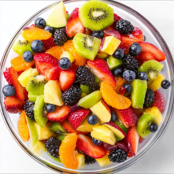 A bowl of fruit salad with kiwi, strawberries, blueberries, and oranges.