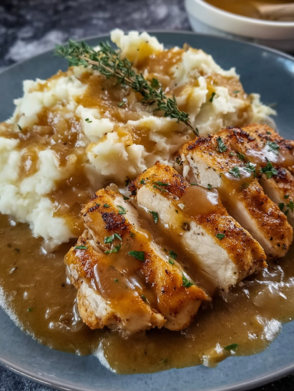 A plate of food with chicken and potatoes.