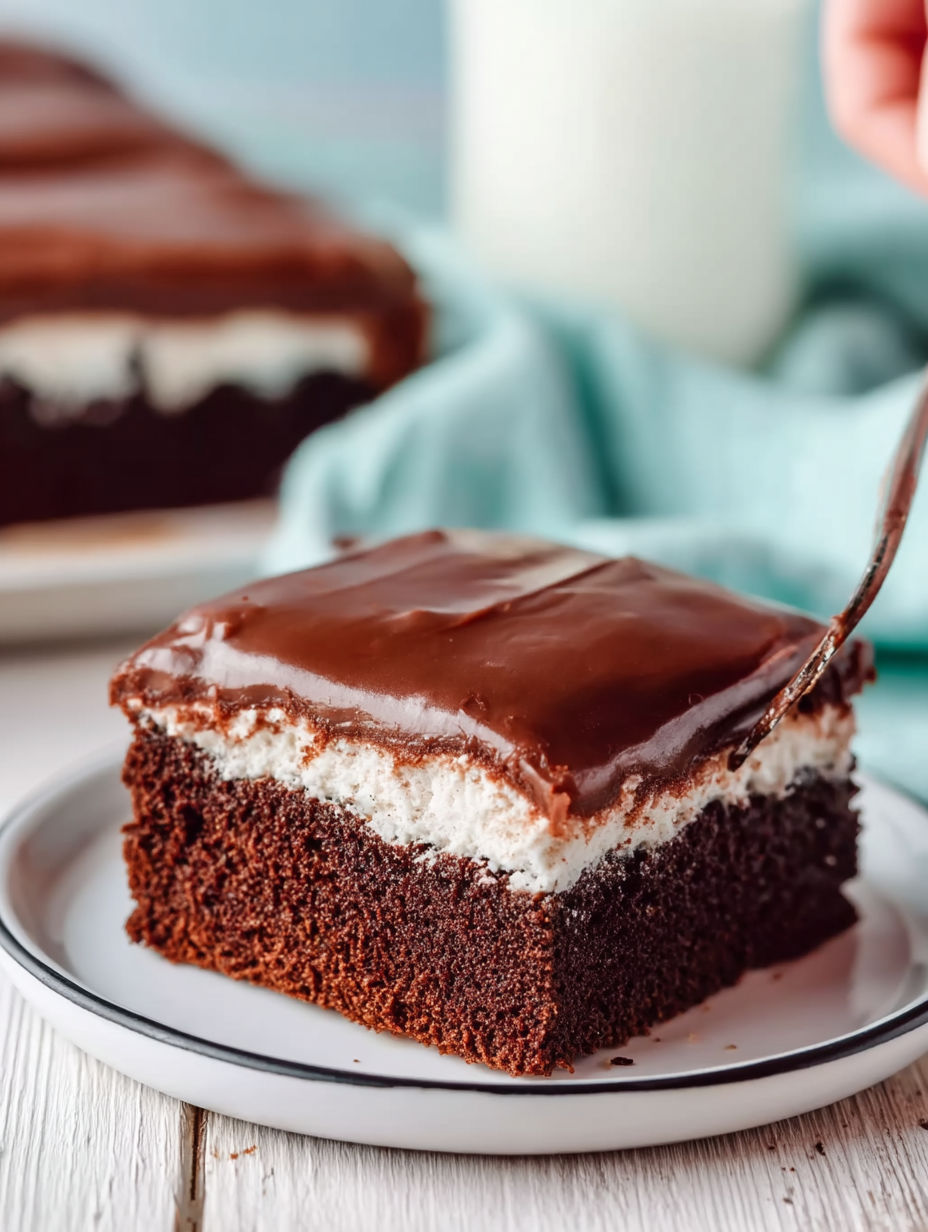 A slice of chocolate cake with white icing.