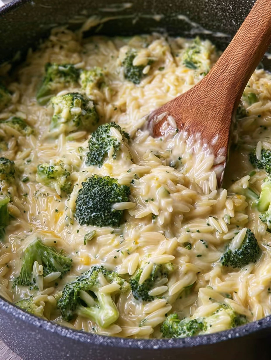 A wooden spoon is in a bowl of rice and broccoli.