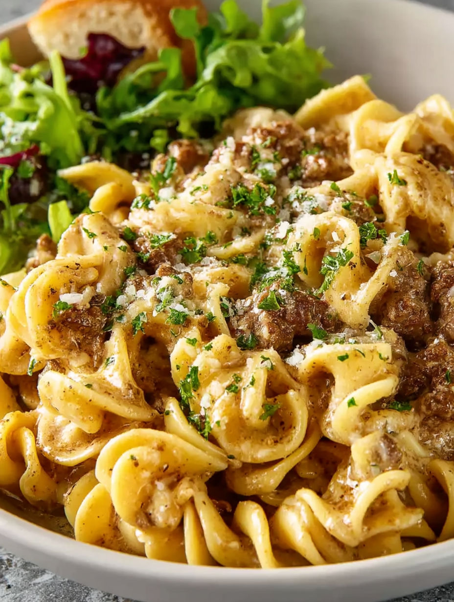 A plate of pasta with meat and cheese.