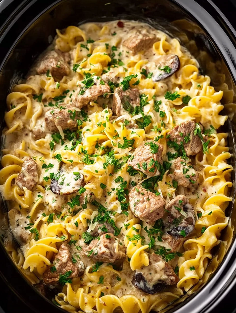 A crock pot filled with beef stroganoff.