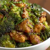 A bowl of chicken and broccoli.