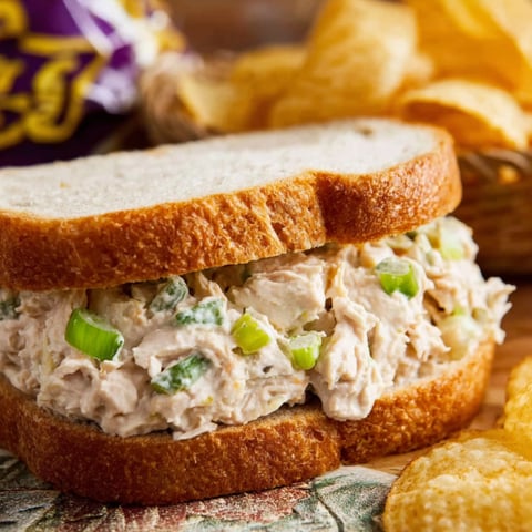 A tuna salad sandwich on a table.