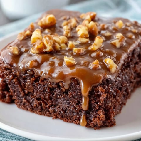 A slice of Texas Sheet Cake with caramel drizzle.