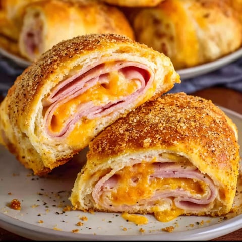 A plate of ham and cheese stromboli.