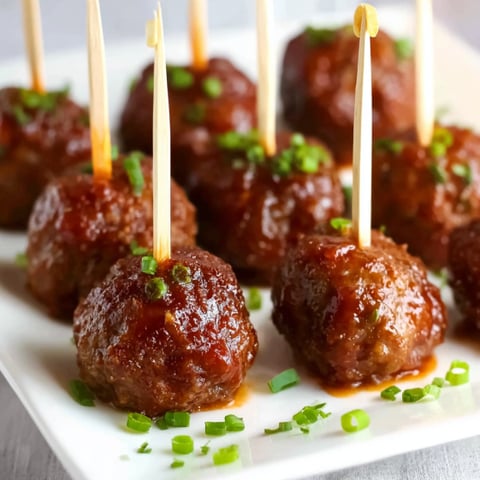 Meatballs on a plate with toothpicks.