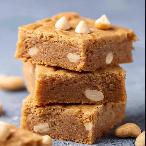 Three pieces of decadent white chocolate blondies.