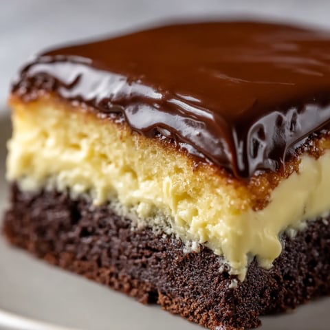 A slice of chocolate cake with white frosting.