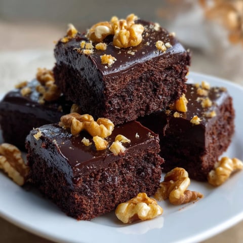 A plate of chocolate cake with walnuts.