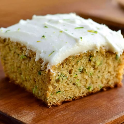 A slice of cake with white frosting.
